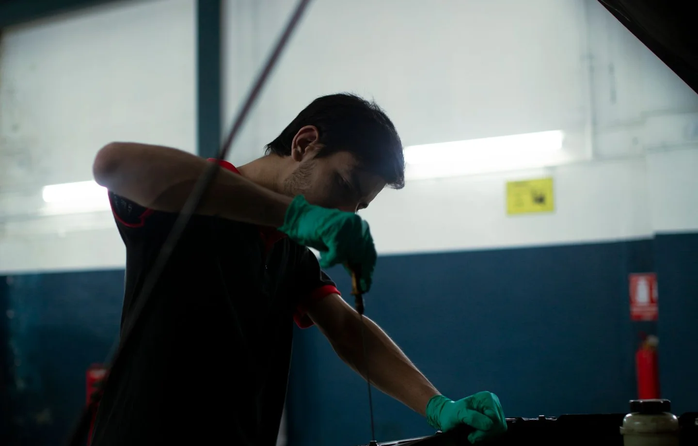 Mechanic checking engine oil