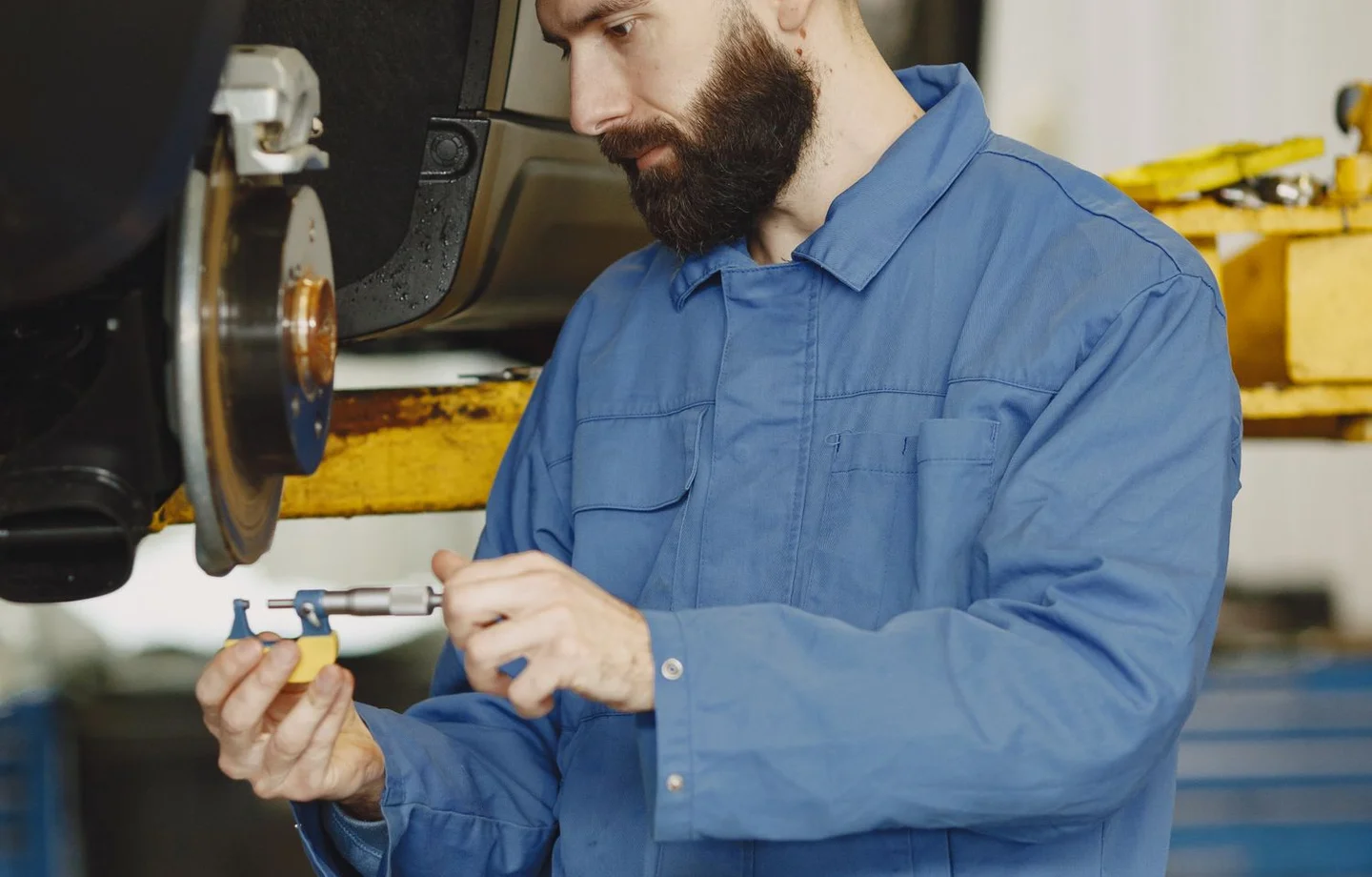 Mechanic inspecting a vehicle brake assembly