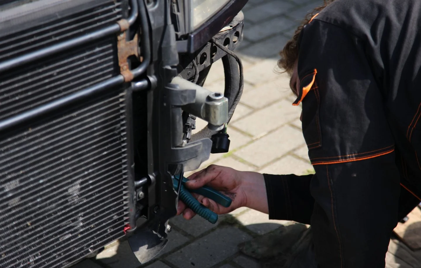 Technician working near the radiator area