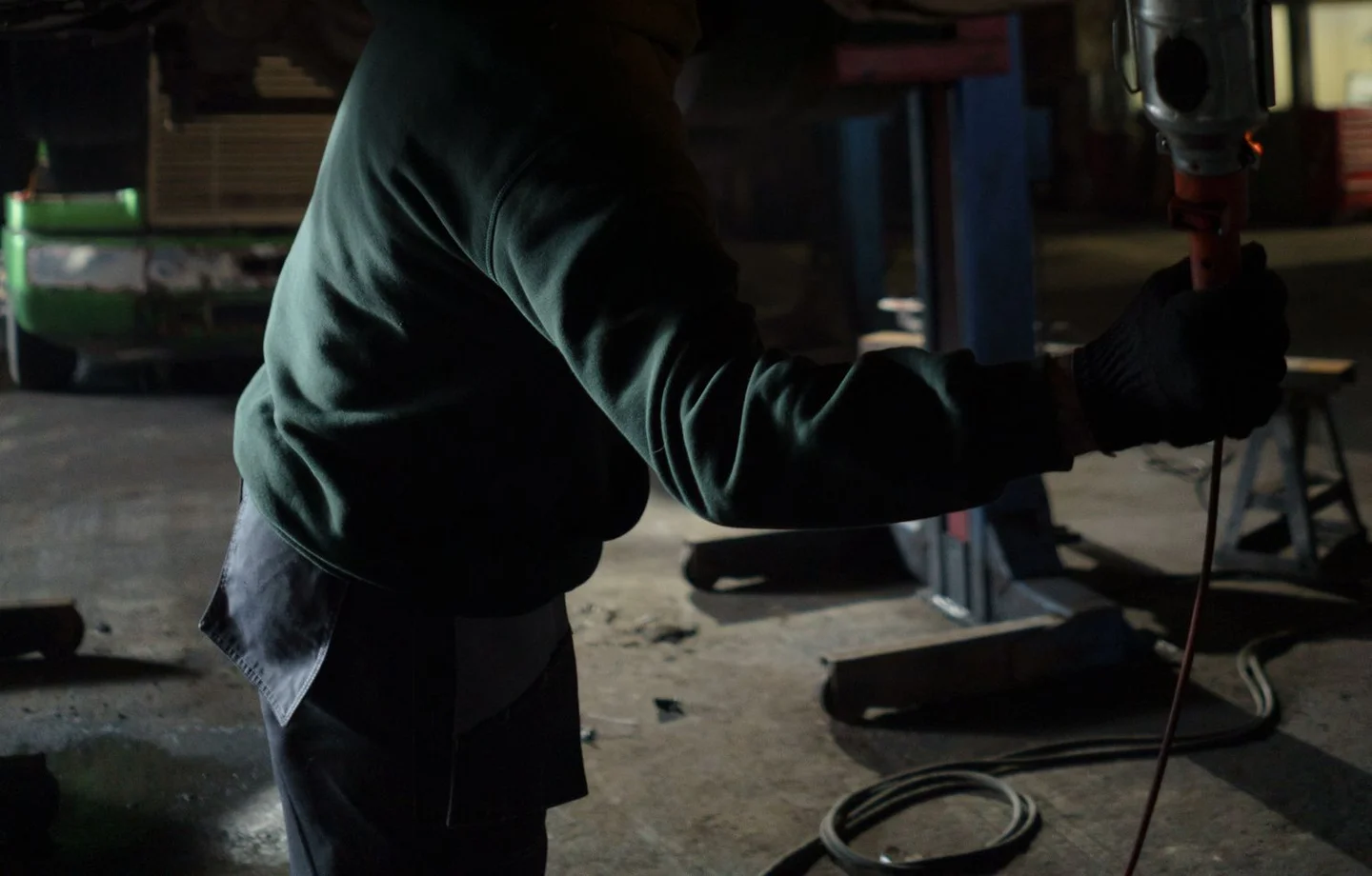 Technician inspecting a vehicle underside