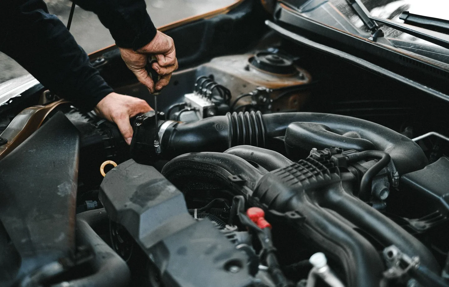 Mechanic inspecting an engine bay