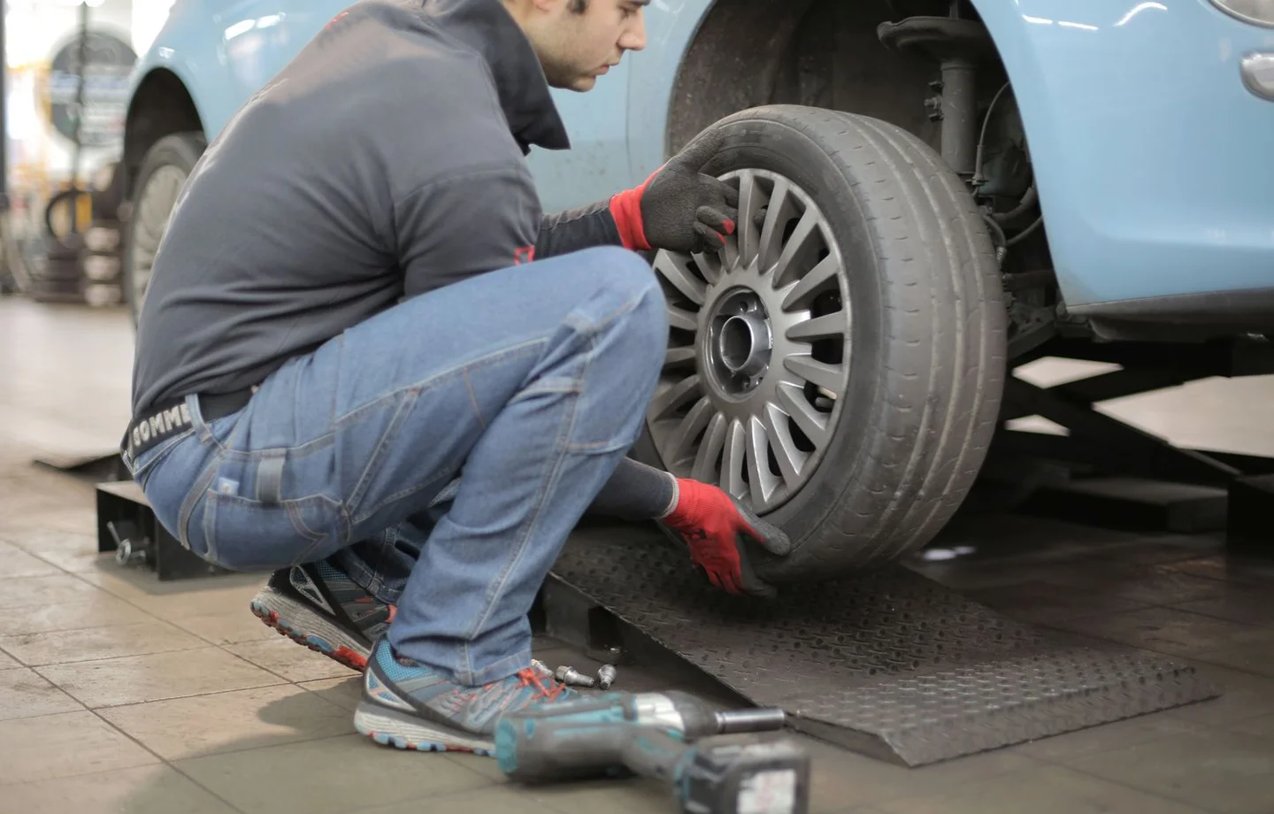 Technician fitting a wheel